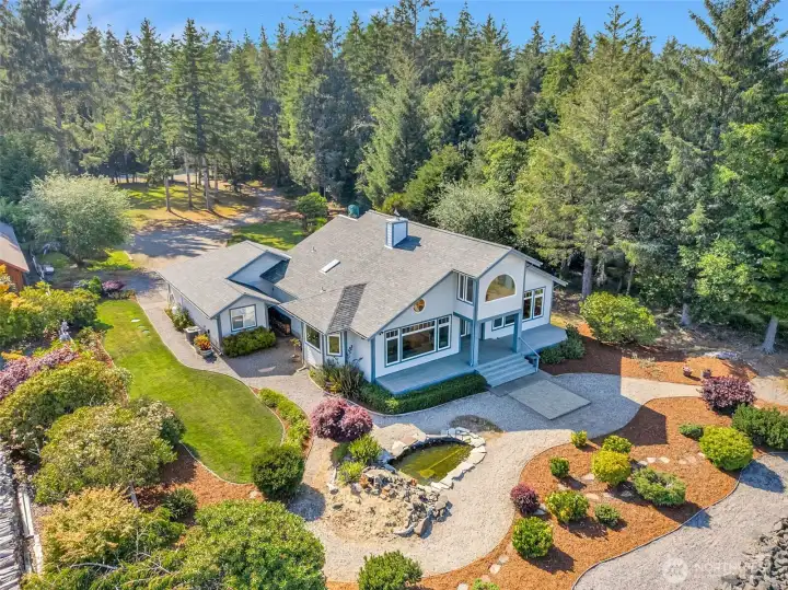 Beautiful aerial view of the home surrounded by mature landscaping, offering privacy and a picturesque setting.