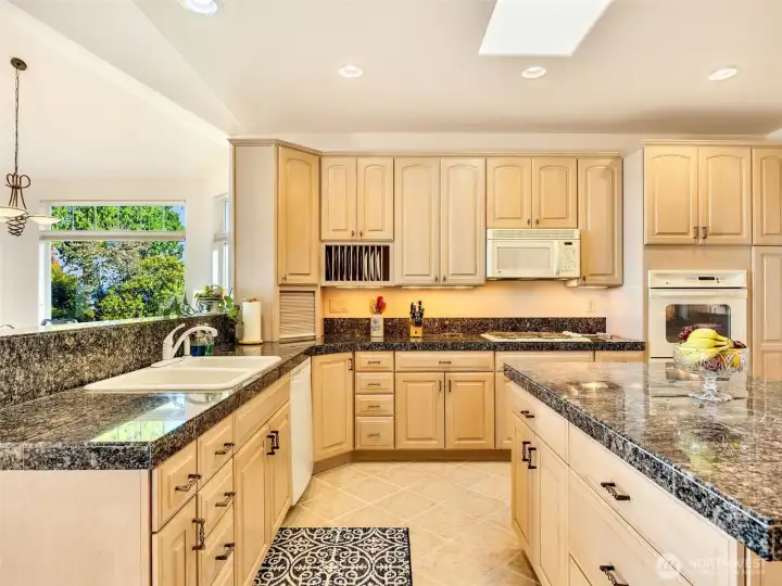 Functional kitchen layout with ample counter space, abundant cabinetry, and an open-concept design.