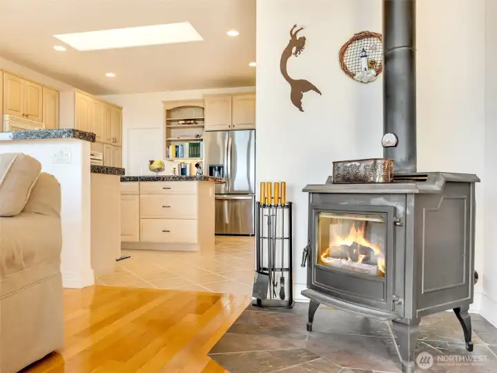 Cozy sitting area featuring a charming freestanding stove, creating a warm and inviting atmosphere.