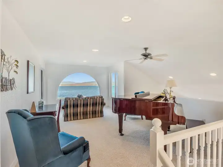 Open loft overlooking the main living area, ideal as a home office, reading nook, or additional gathering space.