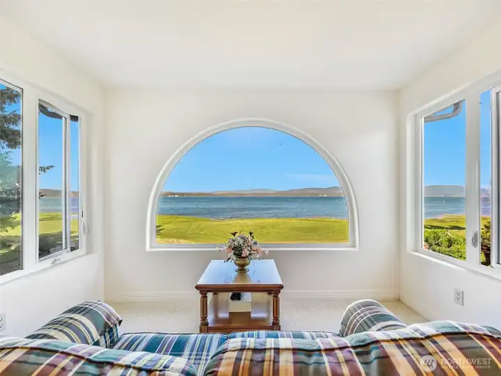 Picture-perfect arched window frames breathtaking panoramic bay views.
