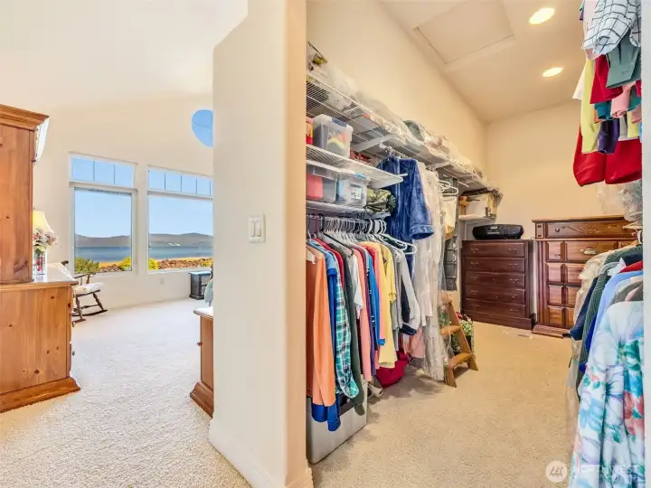 Large walk-in closet with built-in shelving and plenty of storage.