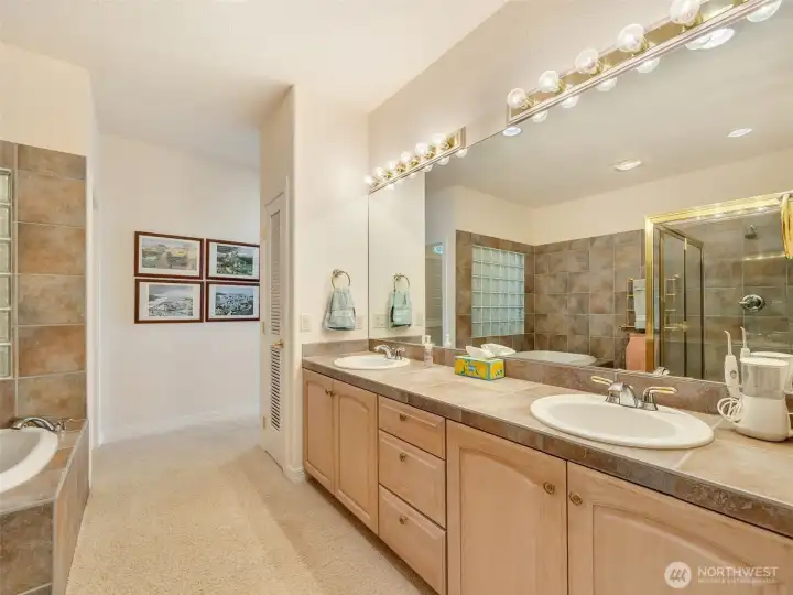 Primary ensuite featuring dual vanities, generous counter space, and abundant storage.