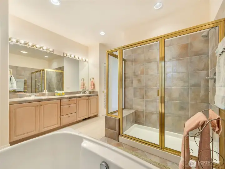 Spacious primary bath designed for comfort with dual sinks, a soaking tub, and separate shower.