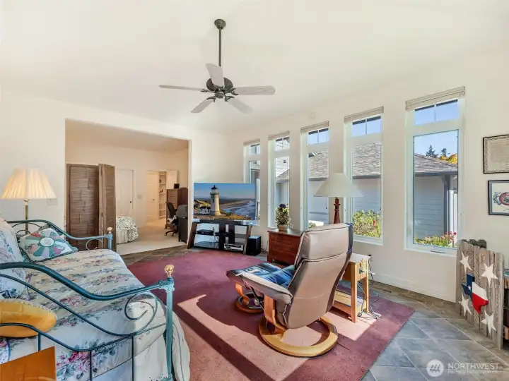 Spacious bonus living area with walls of windows, soaring ceilings, and seamless indoor-outdoor connection.