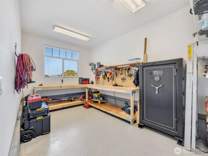 Dedicated workshop space with built-in workbench, ideal for hobbies, projects, or additional storage.
