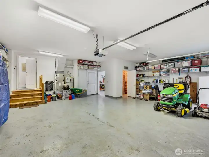 Oversized attached garage offering ample room for vehicles, tools, recreational gear, wine storage and workspace.