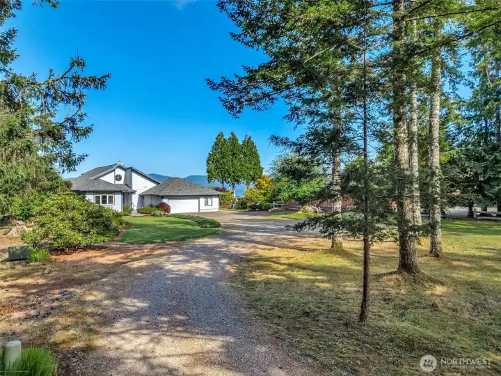Long private driveway welcomes you home while enhancing privacy and providing generous parking.