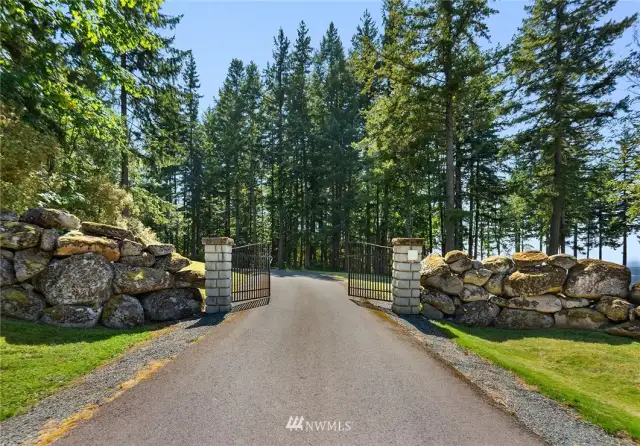 The property is dual gated. This gate leads to the main homes, barns, pasture & guest house. The main house is located 1 mile past this gate. Each gate hosts power & cameras for added security. 