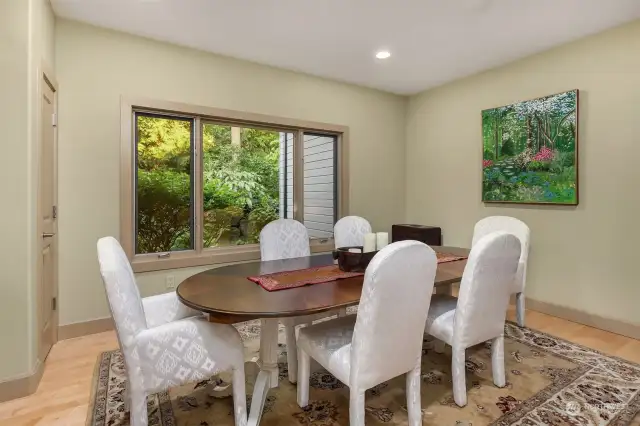 Formal dining area has a beautiful view of the lush garden.
