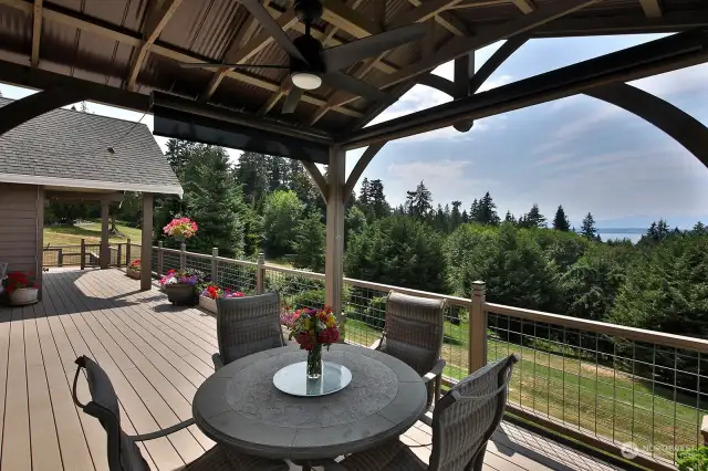 Covered eating area on deck with blinds and a heater.