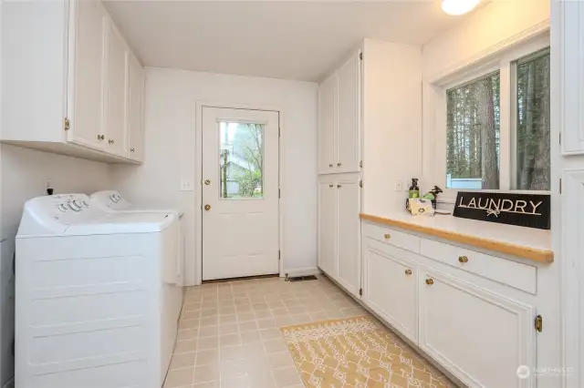 Storage, storage everywhere!!! Abundant pantry space is to the far right. Ahead is a door to the left side yard and A/C unit. And to the left is the door into the extra wide/deep 2-car garage with built-in storage & attic pull-down to even more storage.