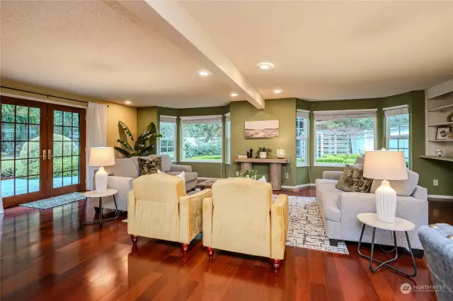 Pretty French doors open to the expansive back deck, play yard and shop beyond. The red brick courtyard can be viewd through bay windows ahead. So pristine, quiet and relaxing.