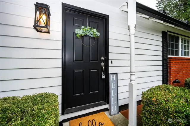 Love the white cedar sidining and the welcoming covered front door!