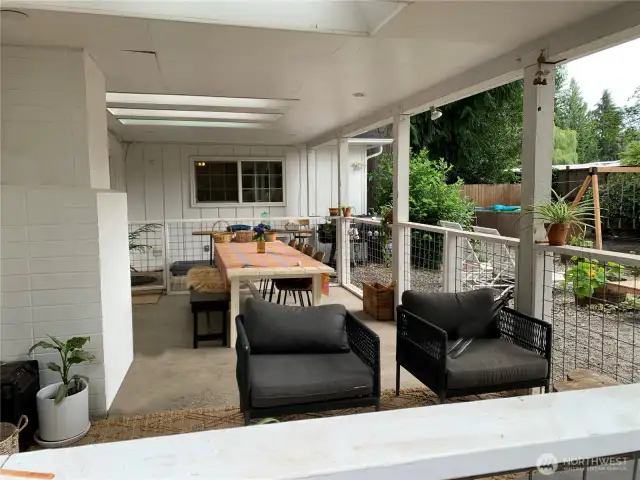 The spacious covered back patio features skylights, creating a bright and inviting setting to relax and enjoy the outdoors.