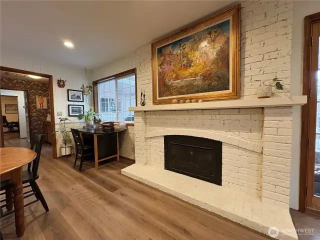 The fireplace is a gas-burning unit with a charming white-painted brick surround, adding warmth and character to the space.