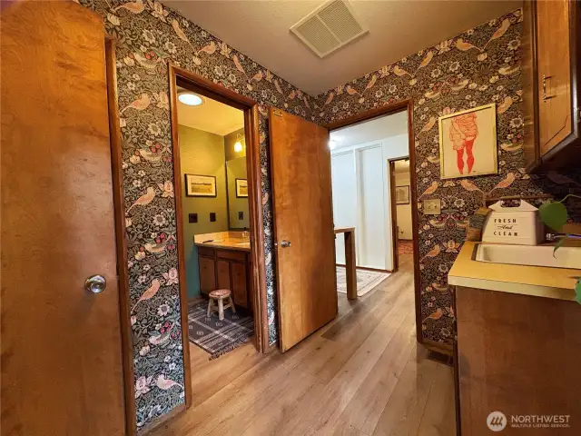 A second back door leads into a convenient mudroom, offering access in three directions—left to the great room, right to the office, laundry room, and family room, or straight ahead to a half bathroom with a walkthrough to the front entry.