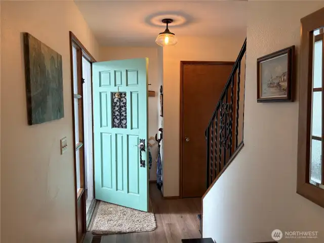 The front door showcases elegant ironwork detailing at eye level, complemented by frosted glass for added privacy and style.