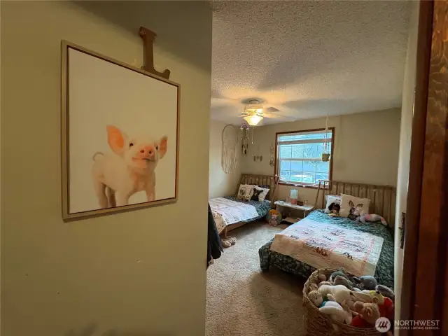 The front bedroom to the left is the smaller of the two front rooms, yet still spacious enough to accommodate two twin beds. It also features a large closet for ample storage.