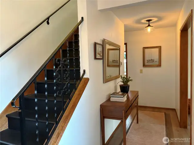 After entering, you can either head upstairs or follow the hallway into the heart of the home.