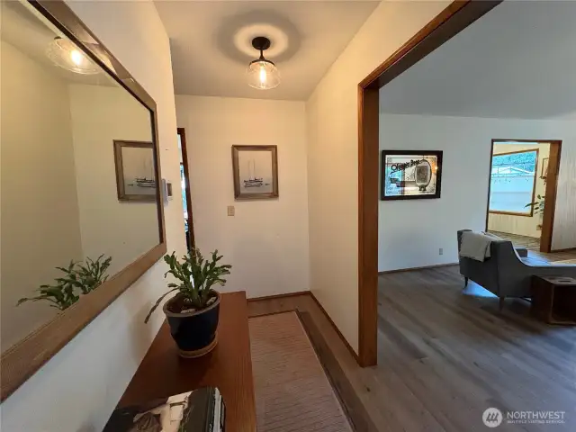 The hallway features a spacious opening into the large living room or continues straight into the kitchen area.