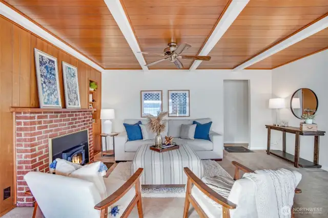 The living features a lovely brick fireplace.