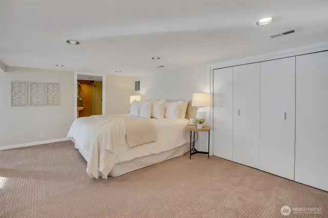 The lower-level primary suite is a private retreat with its own bath, sitting area & water views.
