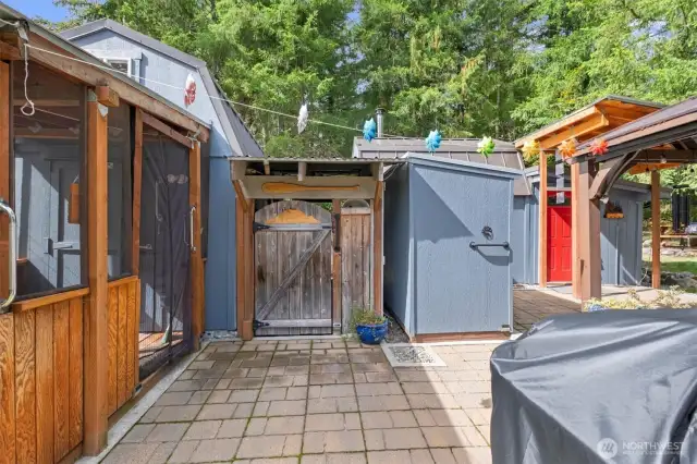 The bathhouse cabin is to the left, or straight ahead to the covered breezeway. A small "hot tub" is in the breezeway as well as the firewood access for the woodstove.