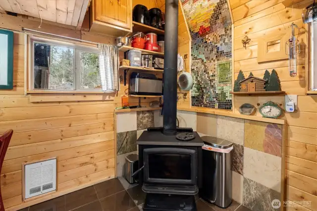 Wood burning stove to stay cozy all winter. Grab firewood right on the otherside of that window in the covered breezeway.