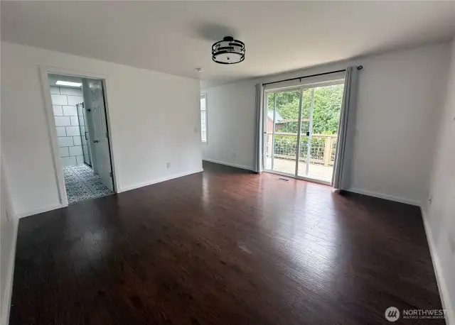 Spacious Master bedroom with en suite bathroom, walk in closet and sliding door leading to the deck