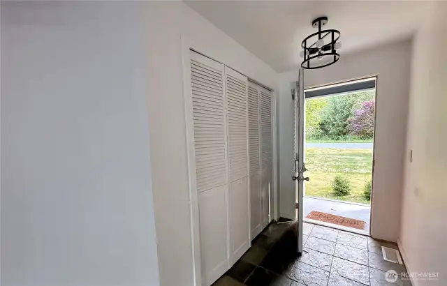 Hallway to front door with hallway closet on entry