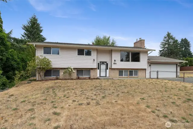 Situated Across from the Golf Course with a large front and back yard and Plenty of Flat Parking Space
