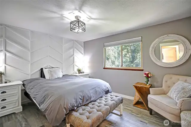 Primary Bedroom with updated lighting, flooring and paint.