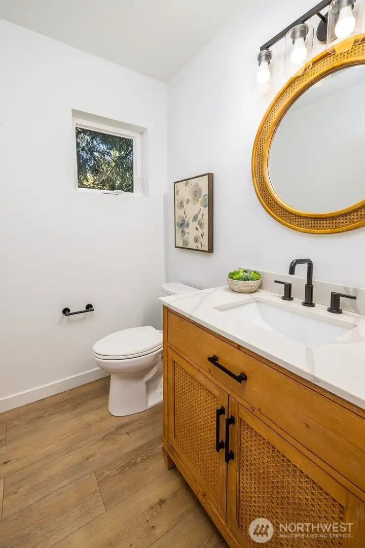 Main floor powder room is sensible in size.