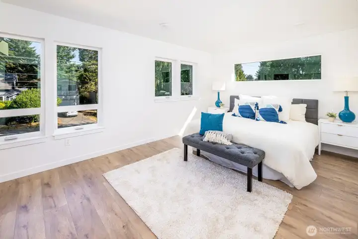 Welcome to your primary ensuite! Double door entry, tons of space for a king bed (shown here) and wall is wired with light switches for night stand lighting and wired for TV install mid wall (no cords).