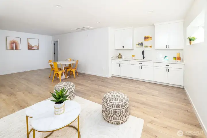 Looking towards the wet bar, kitchen area and extra space in the background. Designed to accommodate a pool table!  Just past there, is more bonus storage space!