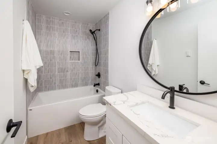 Lower level full bathroom easily accessed from the entrance into the home from the secure two car garage and just across from the 4th bedroom (5th if you count the office space).