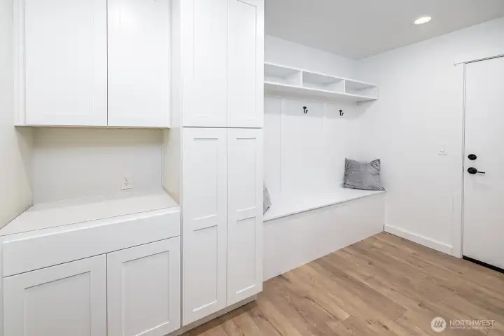 So many extras and bonus spaces for storage in this home.  This is the entry from the garage entrance into a generous mud room, bench, closet system and storage cabinets. It's a fabulous upgrade to the standard builder design!  (countertop has been installed).