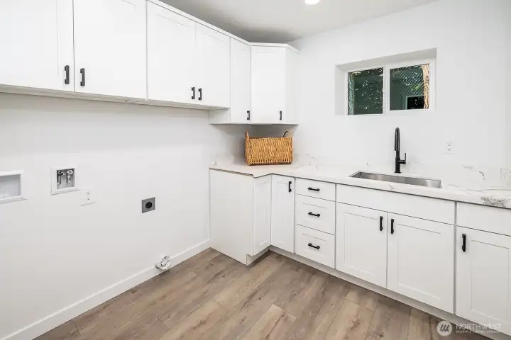 A standout utility room with thoughtful cabinetry, abundant space, and a stylish setting to make laundry feel effortless.