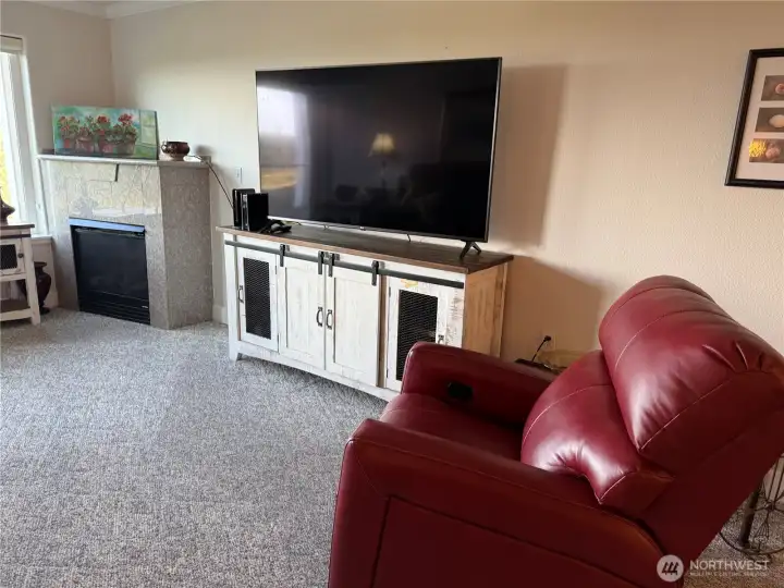 Big screen TV and lovely red recliner included!