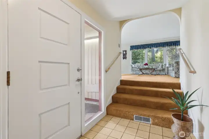 Foyer w/stairs leading to the living room.