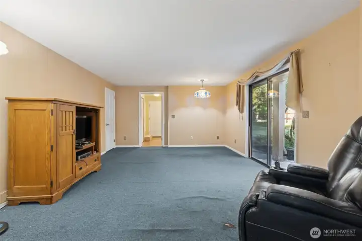 Main floor family room with sliding door to outside. Utility room straight ahead.