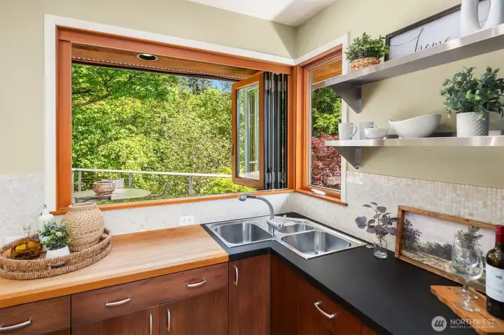 Nana window opens to  granite serving bar on the deck