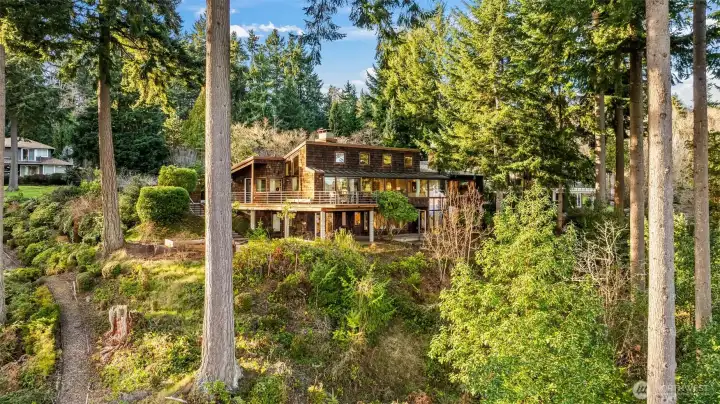 Perched on 100 ft of high bank waterfront overlooking Vashon and Colvos Passage, it is a private, timeless masterpiece presented for only the 2nd time since it was created