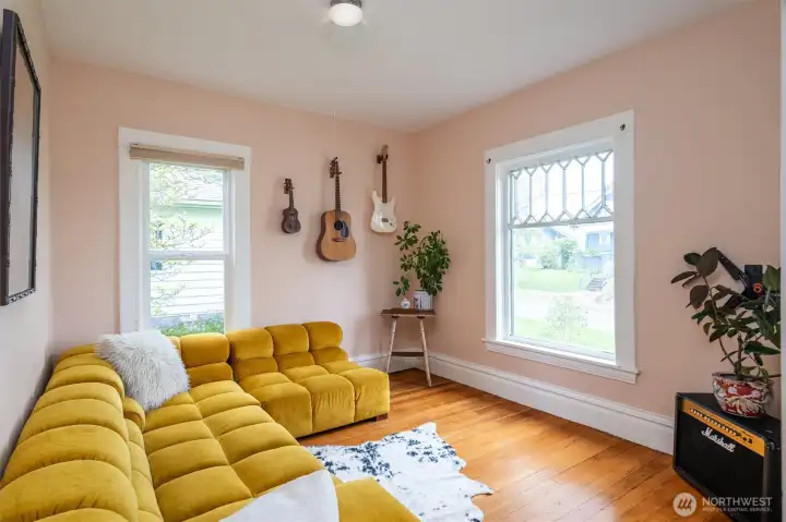 Light and bright living room. Many windows have been updated here, while some original windows have been thoughtfully preserved.