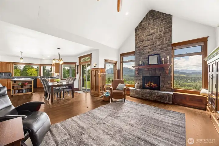 Cultured stone propane fireplace with blower that heats lower-level rooms when on.