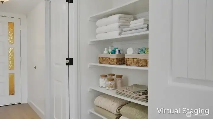 Built-in linen and pantry storage with open shelving, offering convenient and organized space for household essentials.