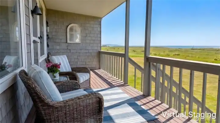 Covered back deck with railing, offering a protected outdoor space to take in expansive dune and ocean views, complete with propane hook-ups for convenient outdoor cooking.