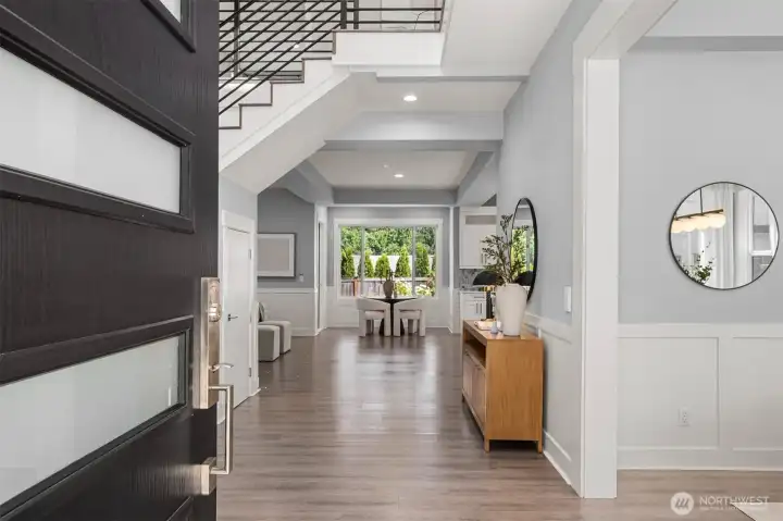 A beautiful grand entry with soaring ceilings, bathed in natural light, welcomes you home.