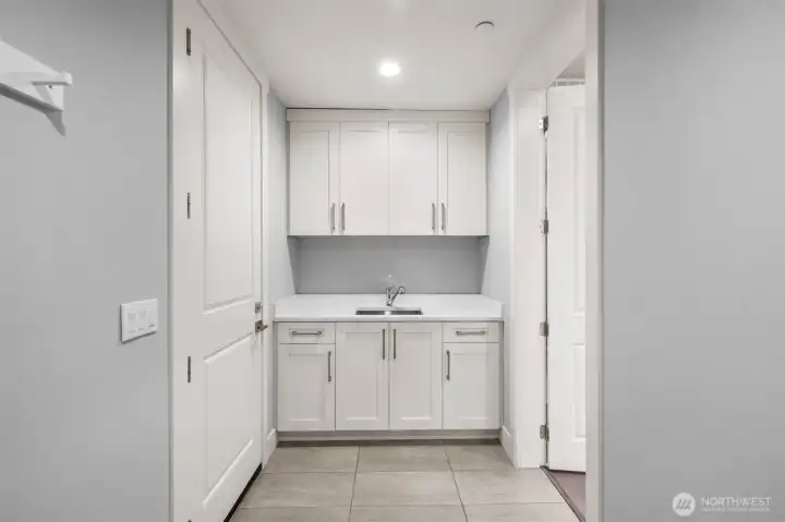 The main floor mudroom is thoughtfully designed and already plumbed for a secondary laundry, offering added convenience and flexibility.